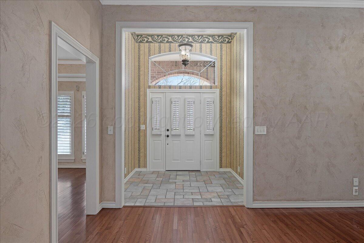 5823 Nicholas Circle Amarillo, TX 79109 - Photo 4 of 31 wooden floor in an empty room with a window