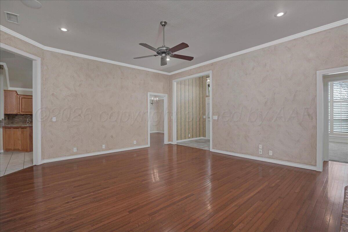 5823 Nicholas Circle Amarillo, TX 79109 - Photo 6 of 31 a view of an empty room with wooden floor and a ceiling fan