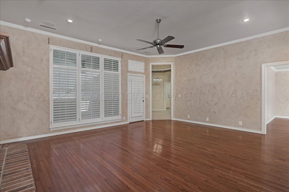 5823 Nicholas Circle Amarillo, TX 79109 - Photo 7 of 31 a view of an empty room with wooden floor and a window