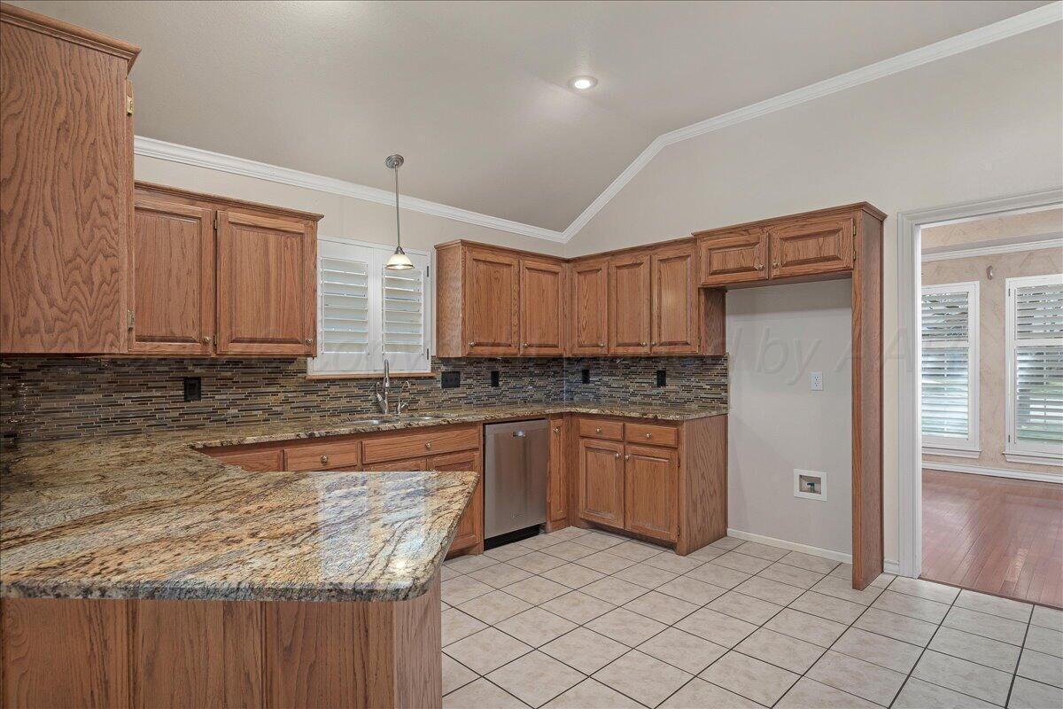 5823 Nicholas Circle Amarillo, TX 79109 - Photo 9 of 31 a kitchen with stainless steel appliances granite countertop a stove a sink and a refrigerator