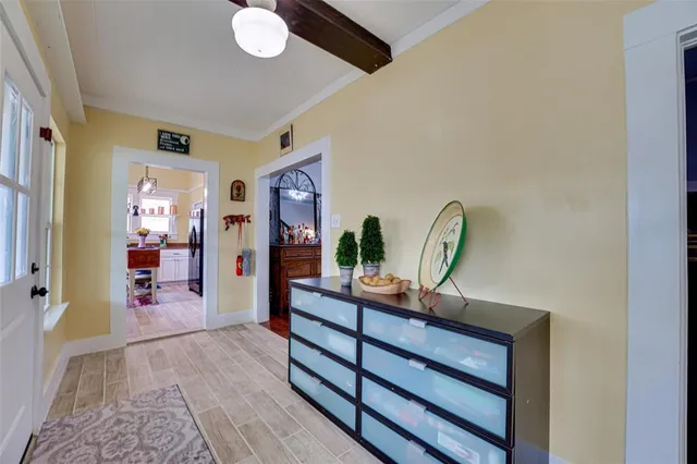 a view of a hallway to a livingroom with furniture