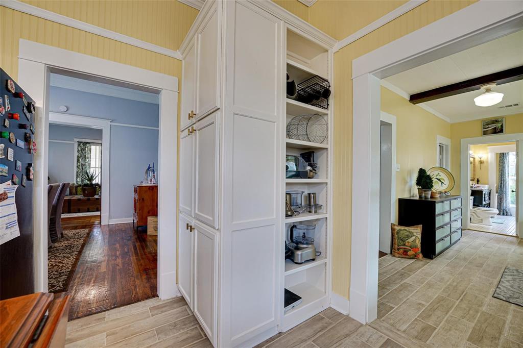1515 Caddo Street Commerce, TX 75428 - Photo 15 of 23 a view of a hallway with wooden floor and furniture
