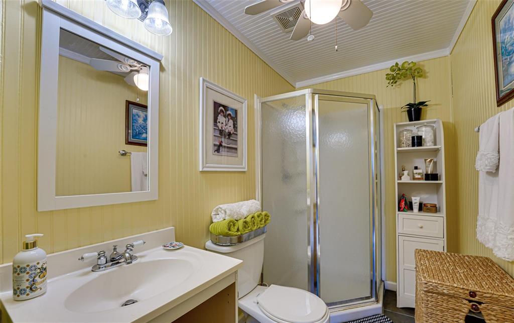1515 Caddo Street Commerce, TX 75428 - Photo 18 of 23 a bathroom with a sink toilet and shower
