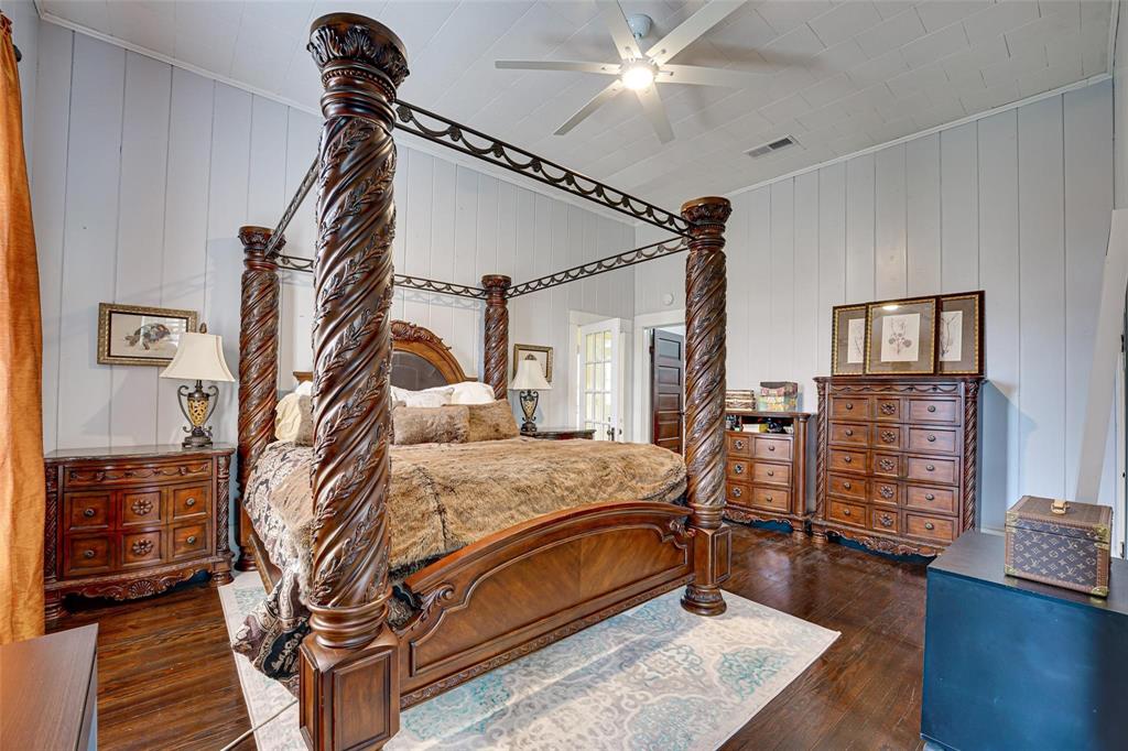 1515 Caddo Street Commerce, TX 75428 - Photo 21 of 23 a bed room with furniture and a ceiling fan