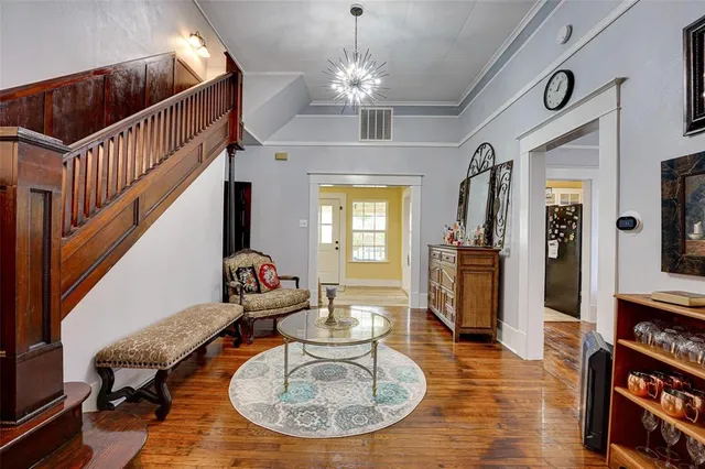 a living room with furniture and a chandelier