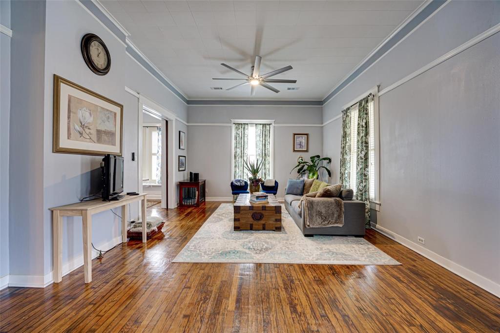 1515 Caddo Street Commerce, TX 75428 - Photo 7 of 23 a living room with furniture and a flat screen tv