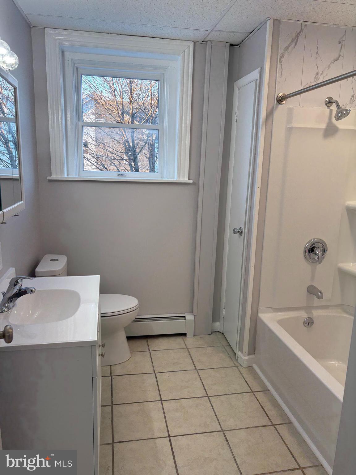 404 Mahoning Street, Unit 2 Lehighton, PA 18235 - Photo 7 of 9 a bathroom with a sink a toilet and shower