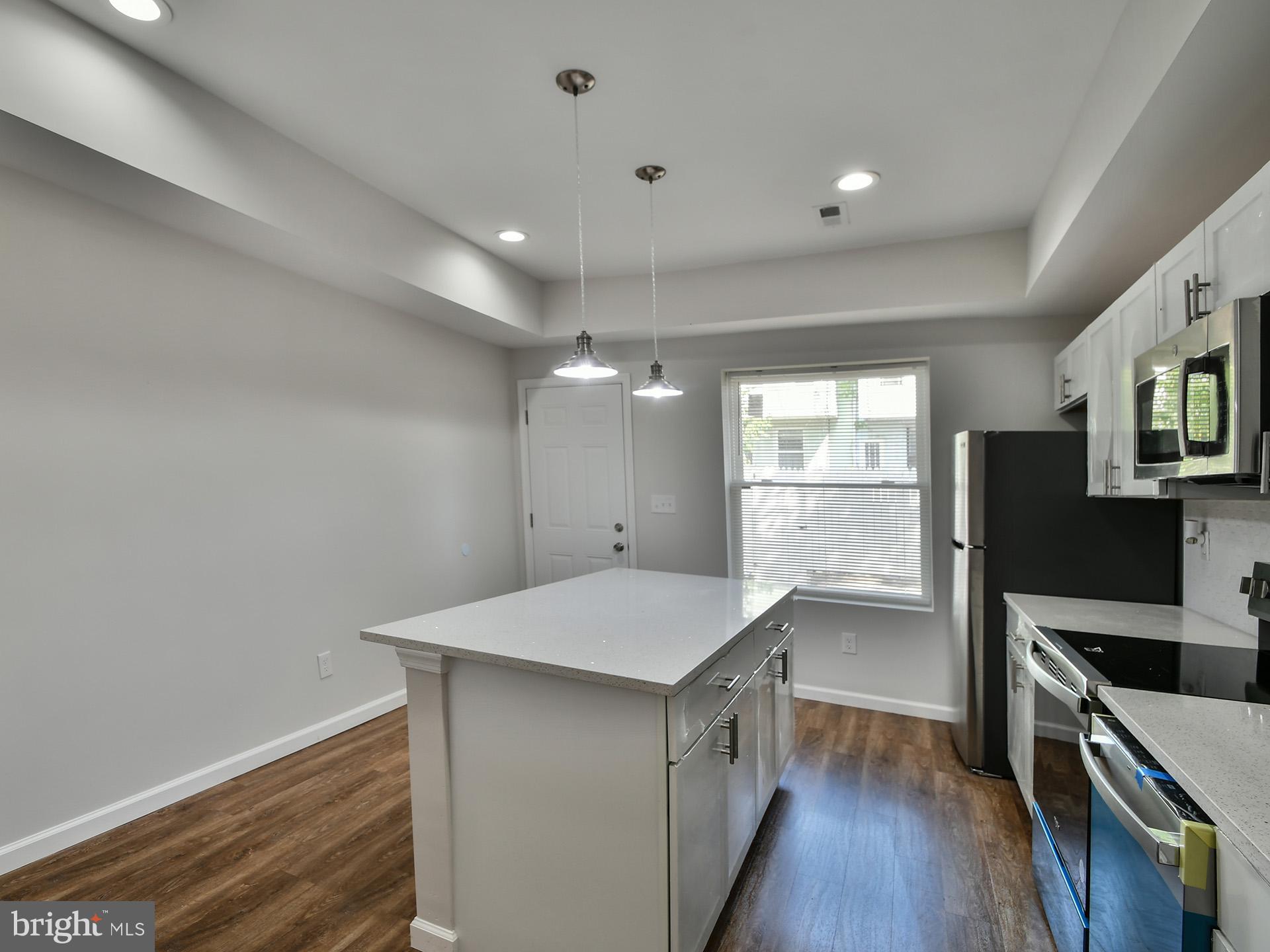 2114 Cliftwood Avenue Baltimore, MD 21213 - Photo 11 of 58 a kitchen with a refrigerator and a stove top oven