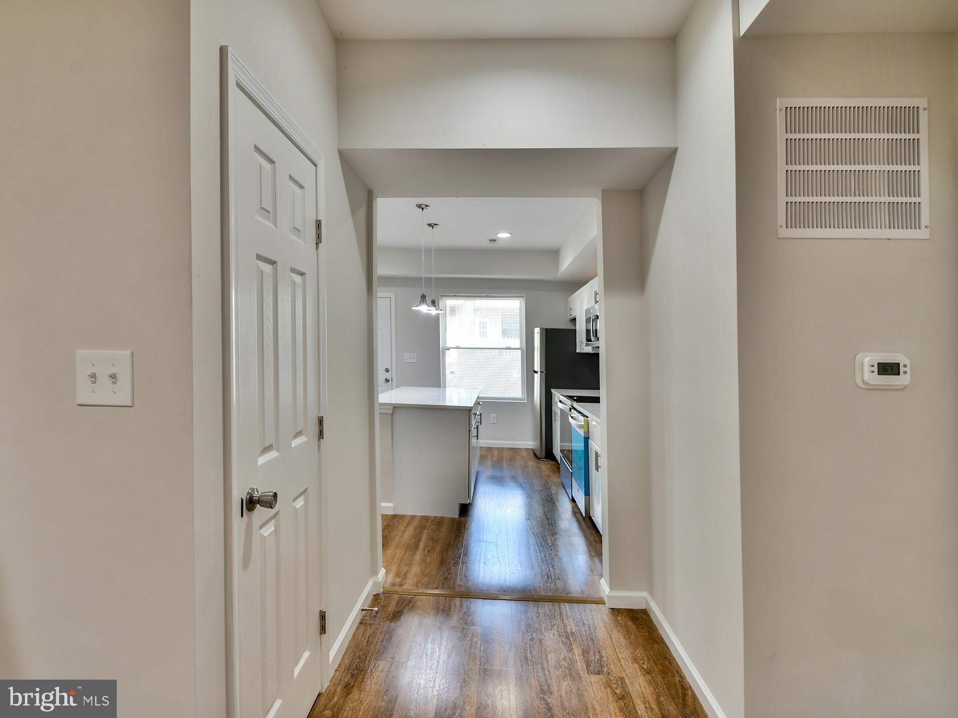 2114 Cliftwood Avenue Baltimore, MD 21213 - Photo 20 of 58 a view of a hallway with wooden floor and staircase
