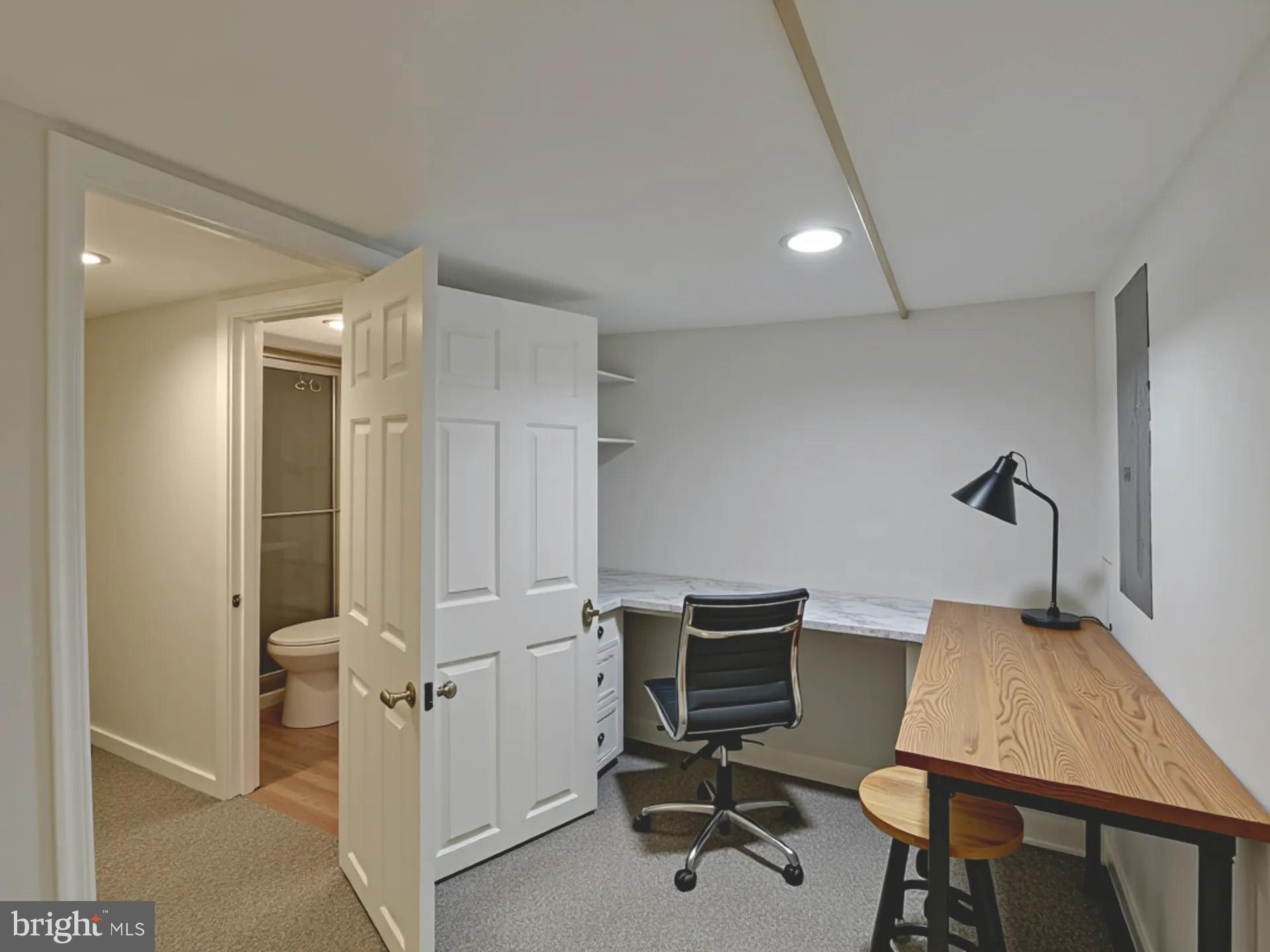 2114 Cliftwood Avenue Baltimore, MD 21213 - Photo 25 of 58 a view of a workspace with furniture and a window