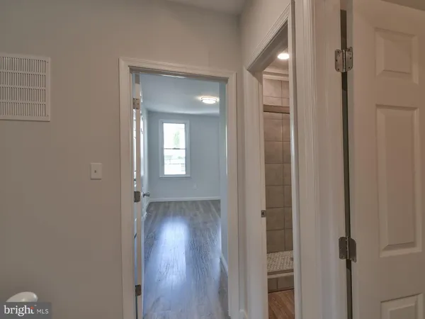 a view of a room with wooden floor