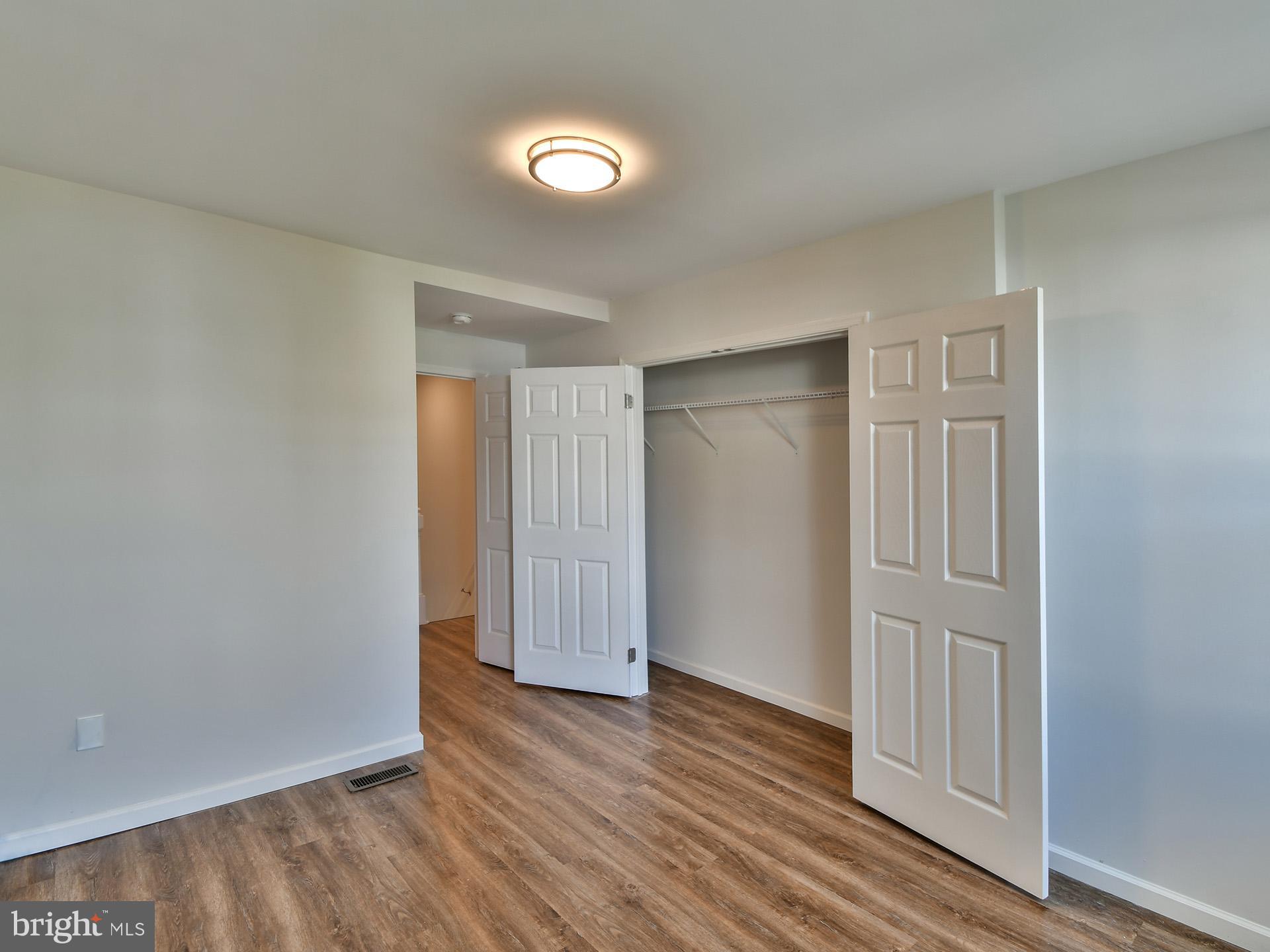2114 Cliftwood Avenue Baltimore, MD 21213 - Photo 34 of 58 a view of an empty room with wooden floor