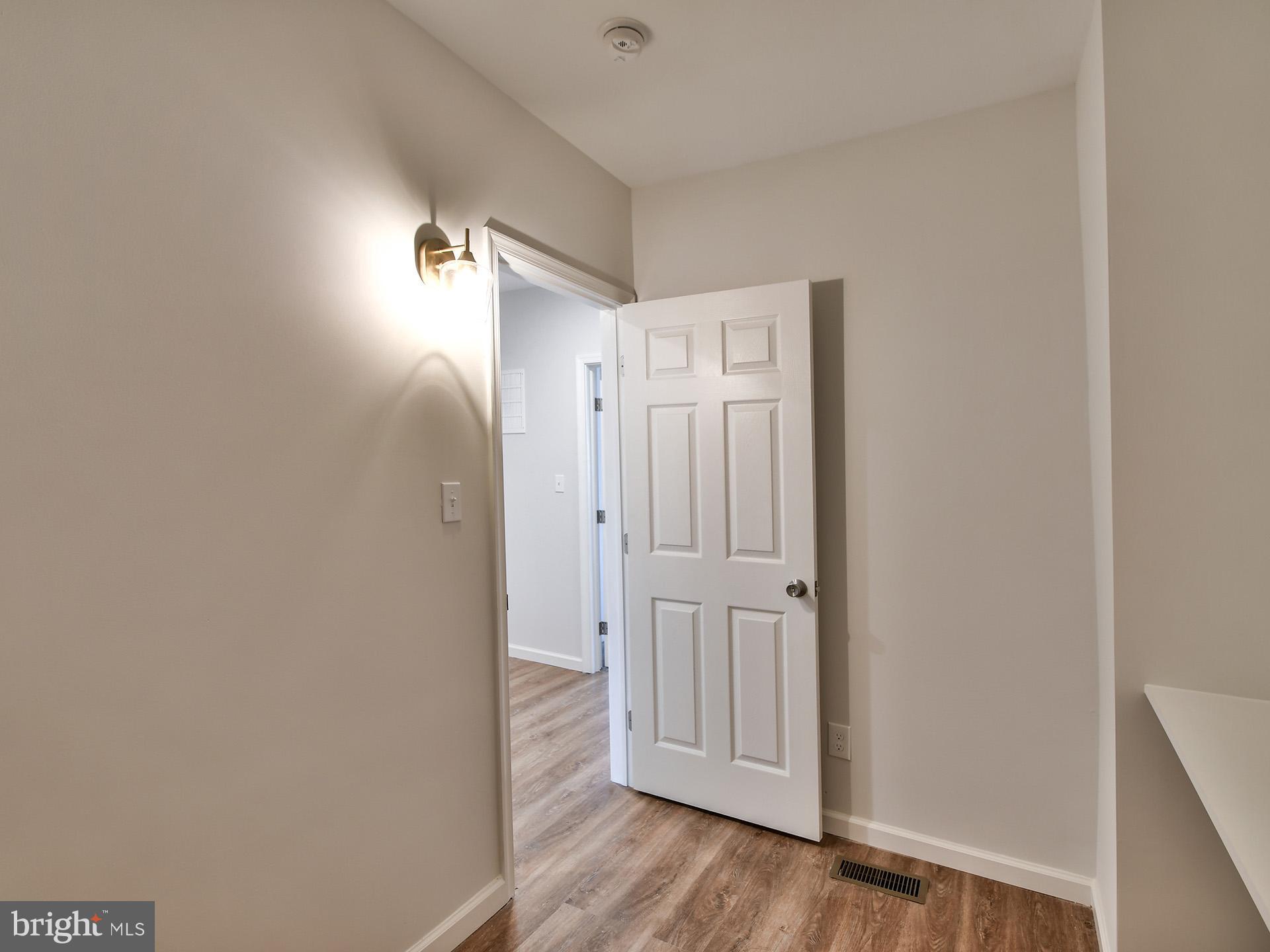 2114 Cliftwood Avenue Baltimore, MD 21213 - Photo 40 of 58 a view of a hallway with wooden floor