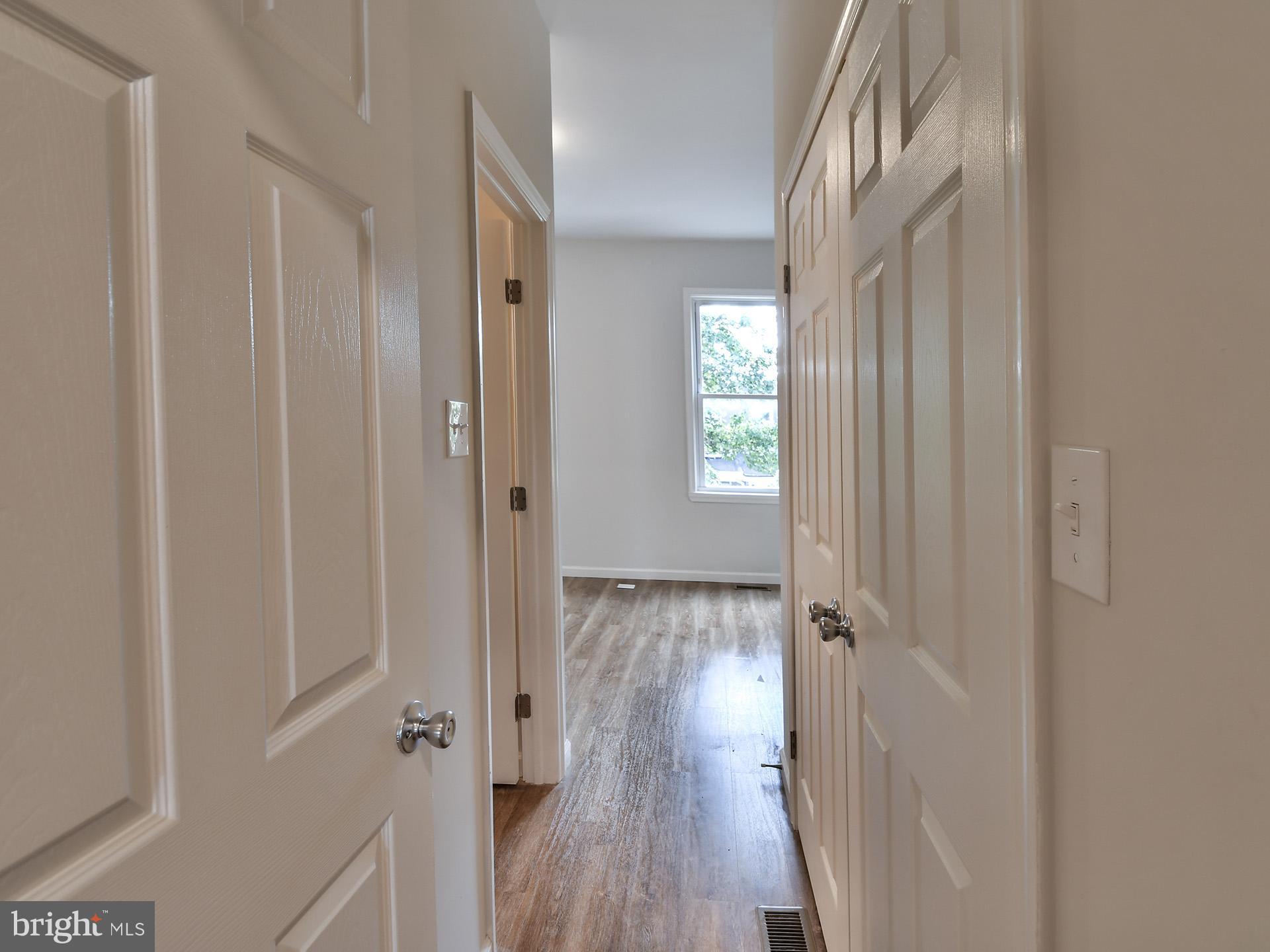 2114 Cliftwood Avenue Baltimore, MD 21213 - Photo 41 of 58 a view of a hallway with wooden floor and closet area