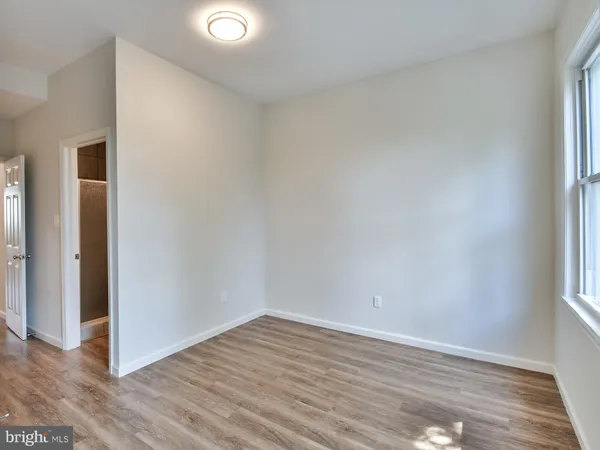 a view of a room with wooden floor