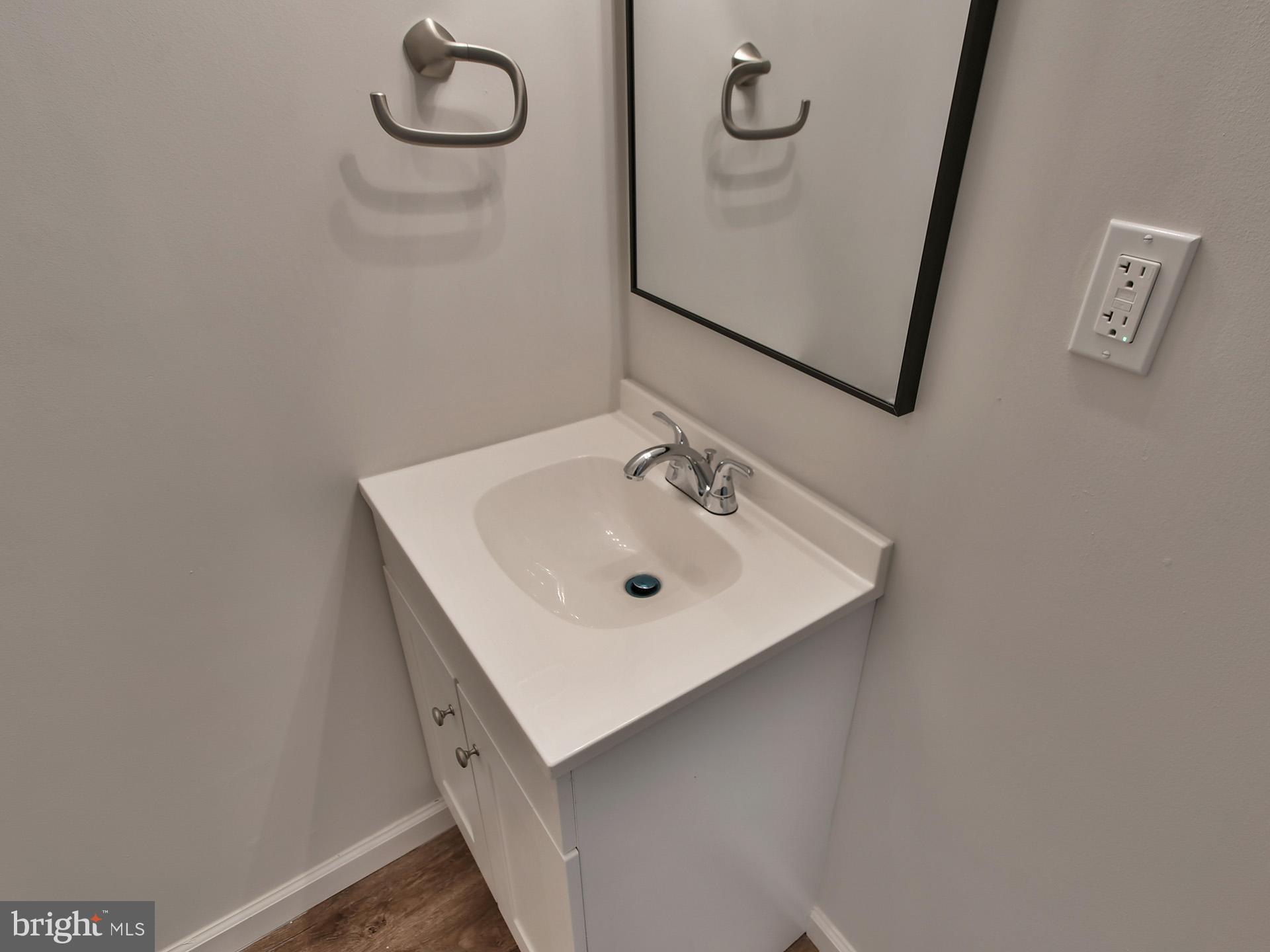 2114 Cliftwood Avenue Baltimore, MD 21213 - Photo 48 of 58 a bathroom with a sink a mirror and vanity