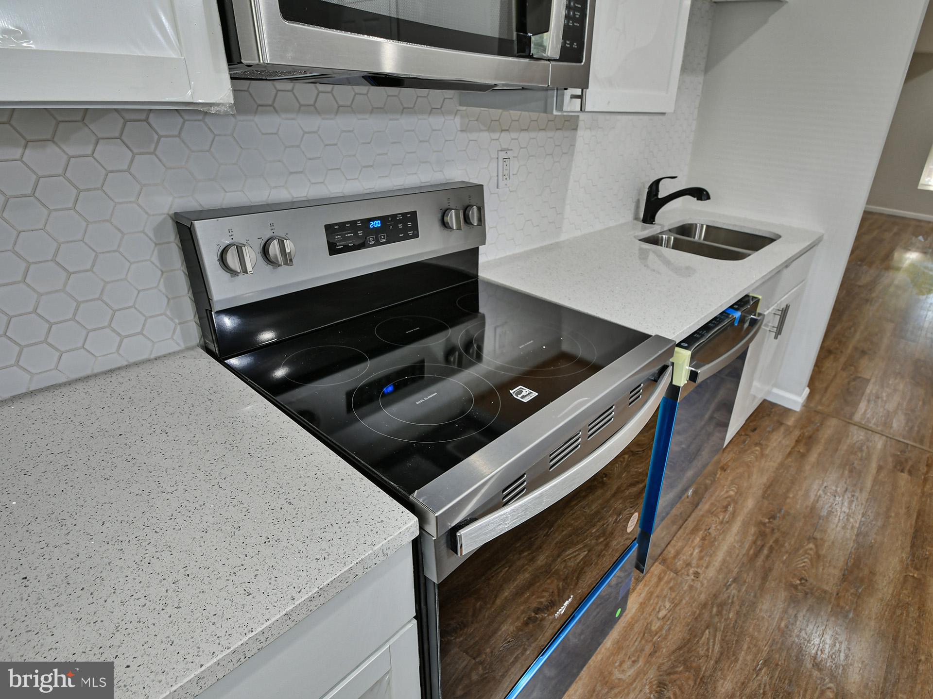 2114 Cliftwood Avenue Baltimore, MD 21213 - Photo 5 of 58 a stove top oven sitting inside of a kitchen