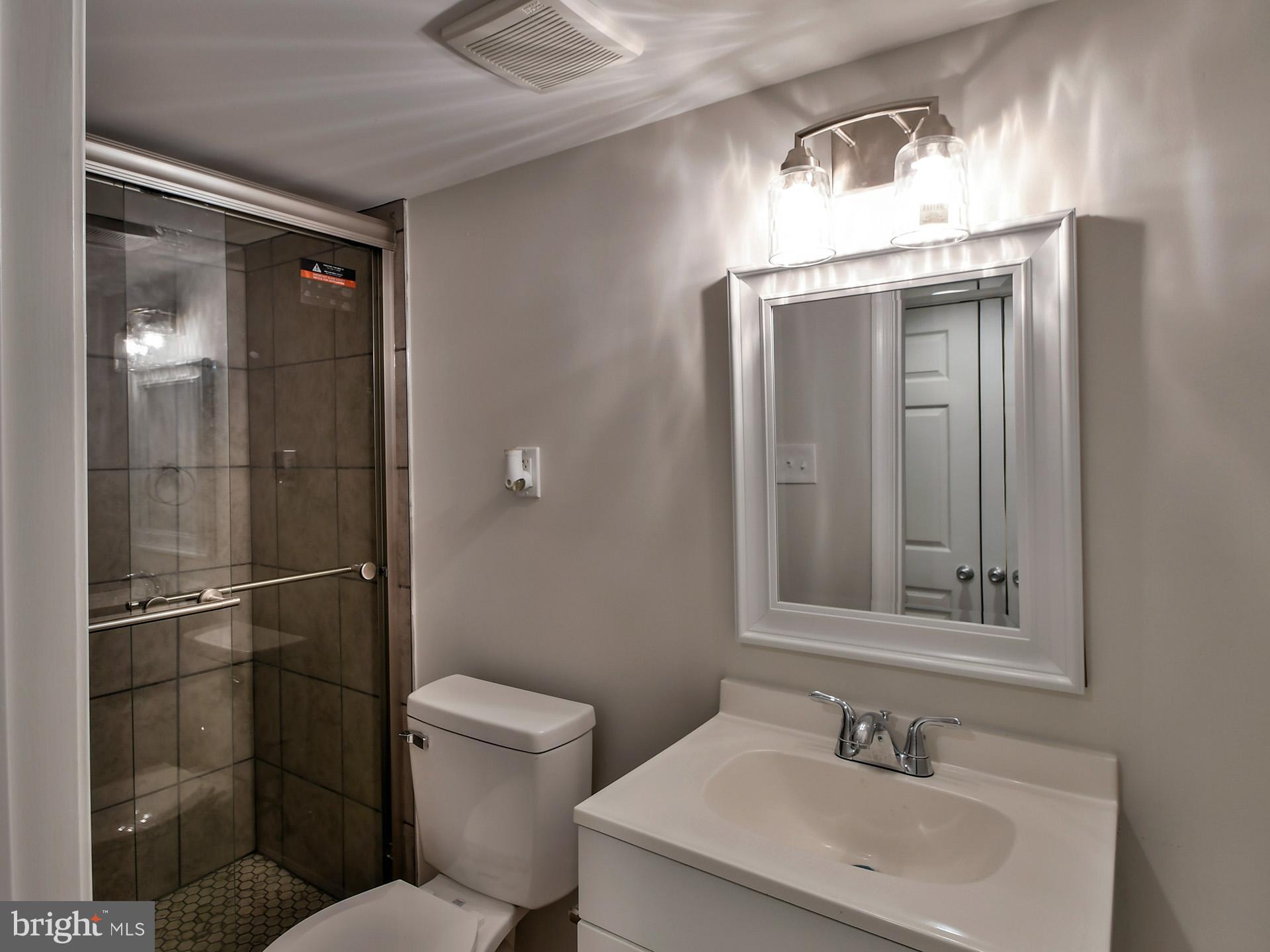 2114 Cliftwood Avenue Baltimore, MD 21213 - Photo 58 of 58 a bathroom with a sink toilet and shower