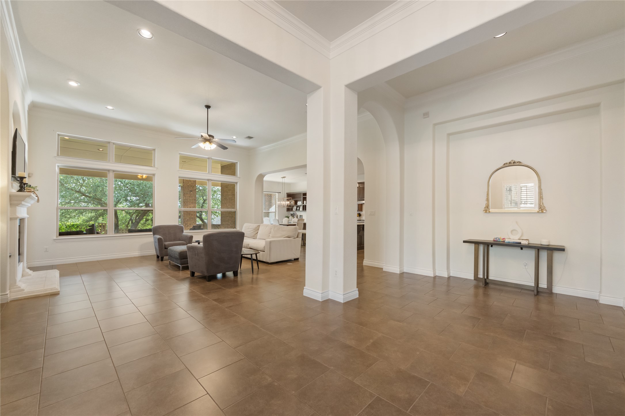 415 Bitterroot Lane Austin, TX 78737 - Photo 8 of 25 A spacious living area with tall windows, tile flooring, and elegant architectural details.