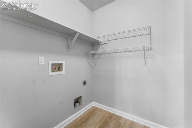 7515 Farmcrest Road Colorado Springs, CO 80925 - Photo 24 of 40 Laundry room with washer hookup, wood-type flooring, and hookup for an electric dryer