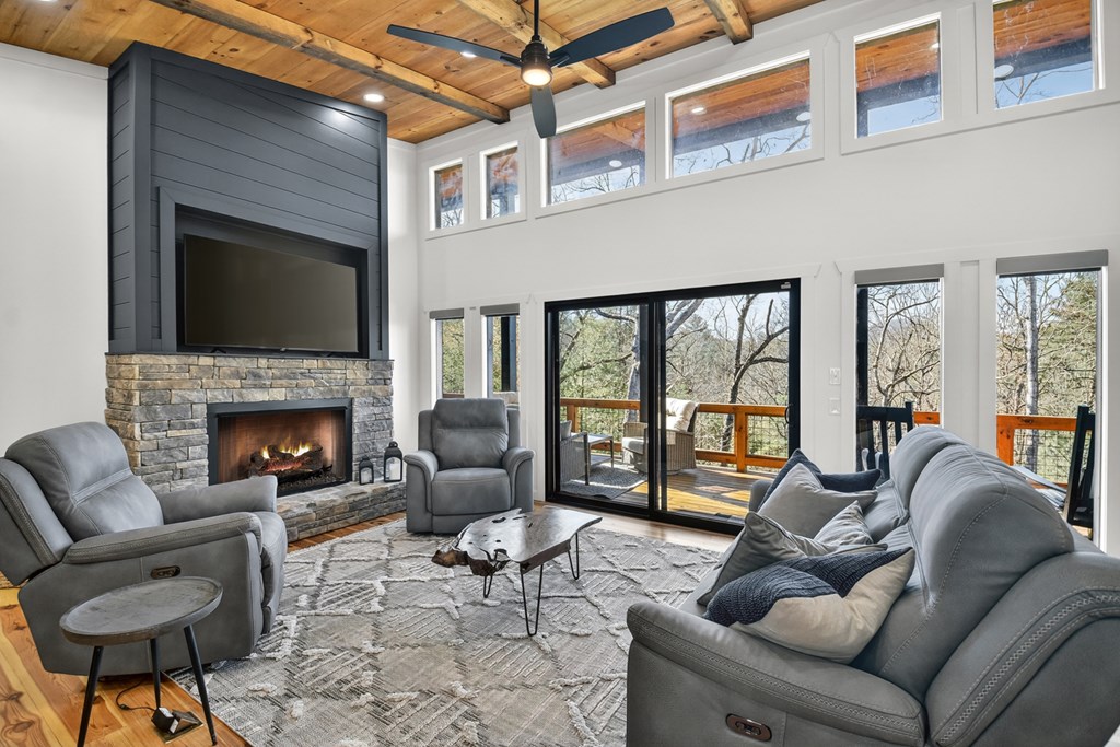 238 Hooch Holler Lane Morganton, GA 30560 - Photo 16 of 49 a living room with furniture a fireplace and a flat screen tv