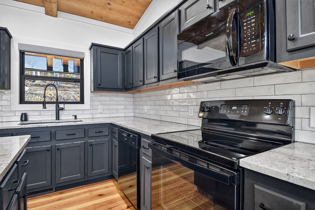 238 Hooch Holler Lane Morganton, GA 30560 - Photo 24 of 49 a kitchen with a sink stove and cabinets