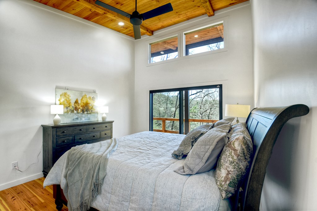 238 Hooch Holler Lane Morganton, GA 30560 - Photo 29 of 49 a bed sitting in a bedroom next to a window