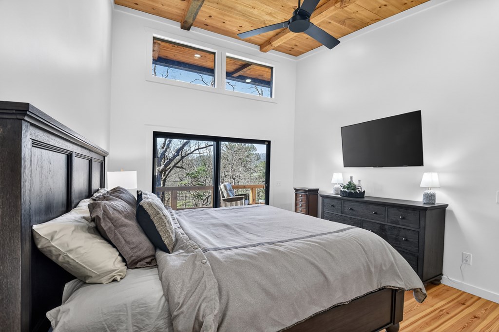 238 Hooch Holler Lane Morganton, GA 30560 - Photo 34 of 49 a bedroom with a bed and a flat tv screen on dresser