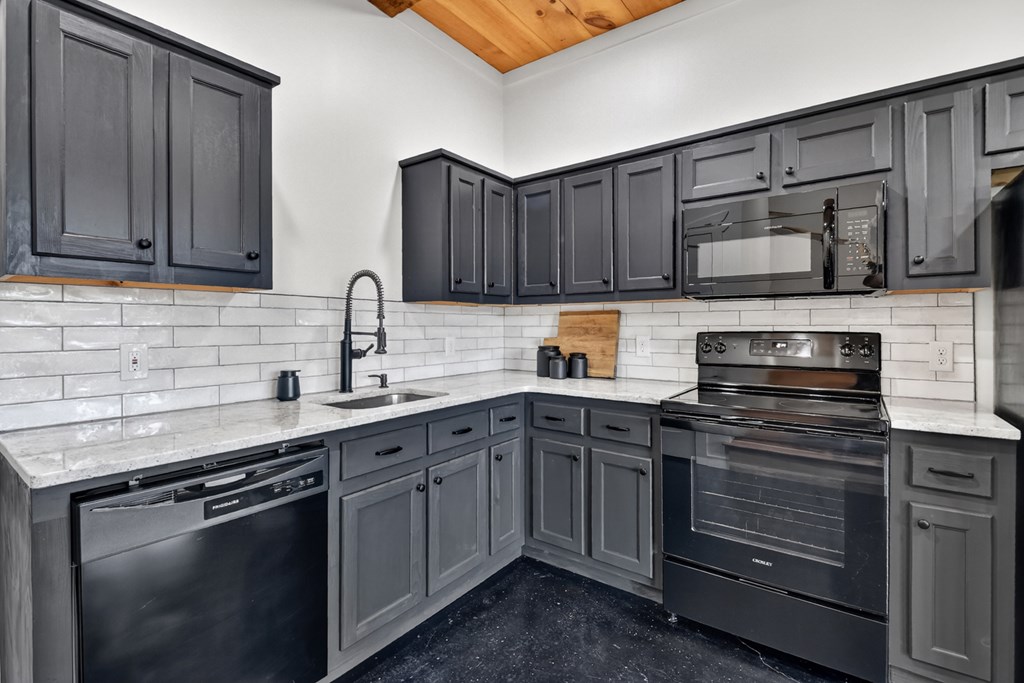 238 Hooch Holler Lane Morganton, GA 30560 - Photo 39 of 49 a kitchen with stainless steel appliances granite countertop wooden cabinets stove top oven and sink