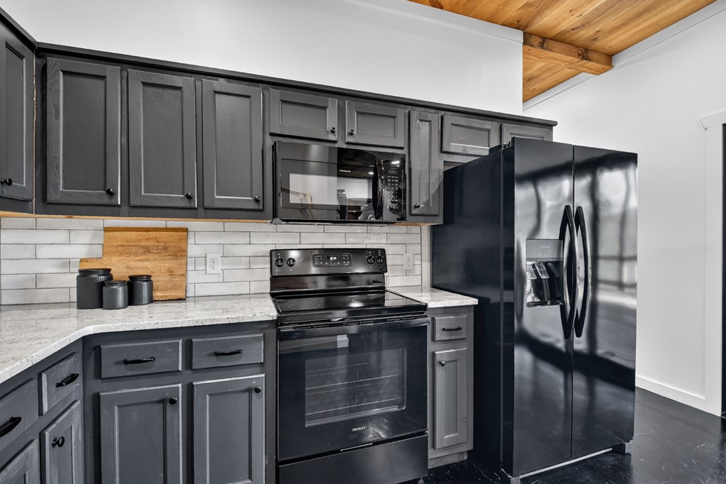 238 Hooch Holler Lane Morganton, GA 30560 - Photo 40 of 49 a kitchen with granite countertop a refrigerator stove and microwave