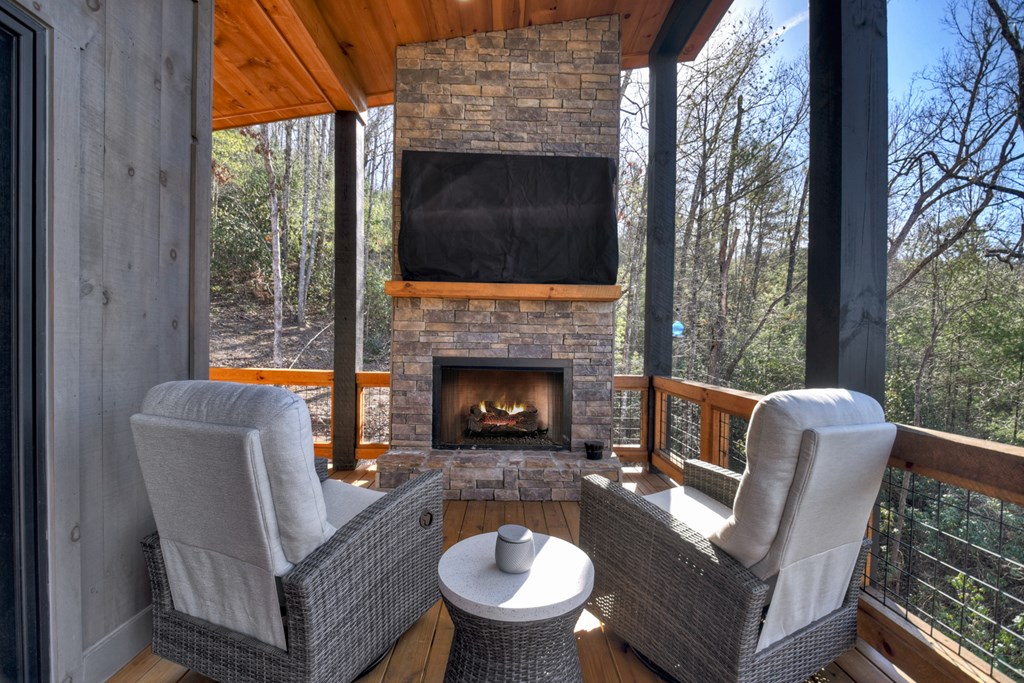 238 Hooch Holler Lane Morganton, GA 30560 - Photo 10 of 49 a living room with furniture a fireplace and a floor to ceiling window