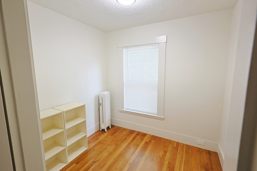 11 Channing Street, Unit 2 Newton, MA 02458 - Photo 29 of 33 a view of an empty room with wooden floor and a window