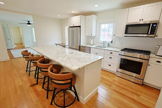 a kitchen with stainless steel appliances a stove a sink and a refrigerator