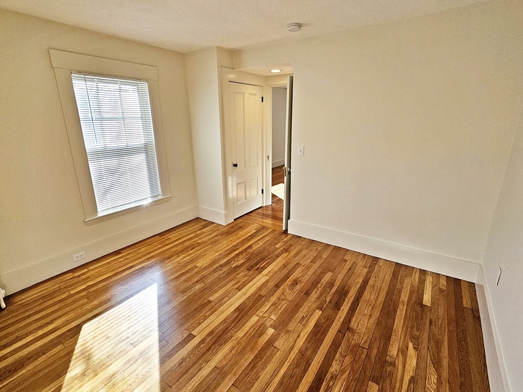 11 Channing Street, Unit 2 Newton, MA 02458 - Photo 8 of 33 a view of an empty room and wooden floor