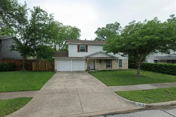 a front view of a house with yard