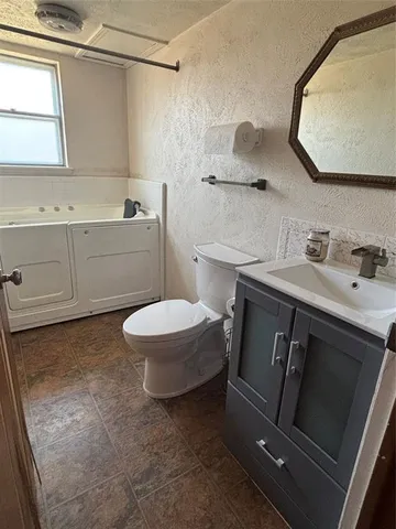 a bathroom with a sink a toilet and a mirror