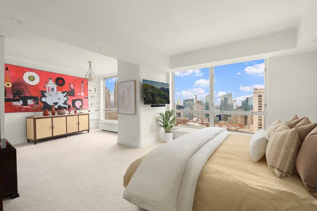 a bedroom with furniture and a flat screen tv