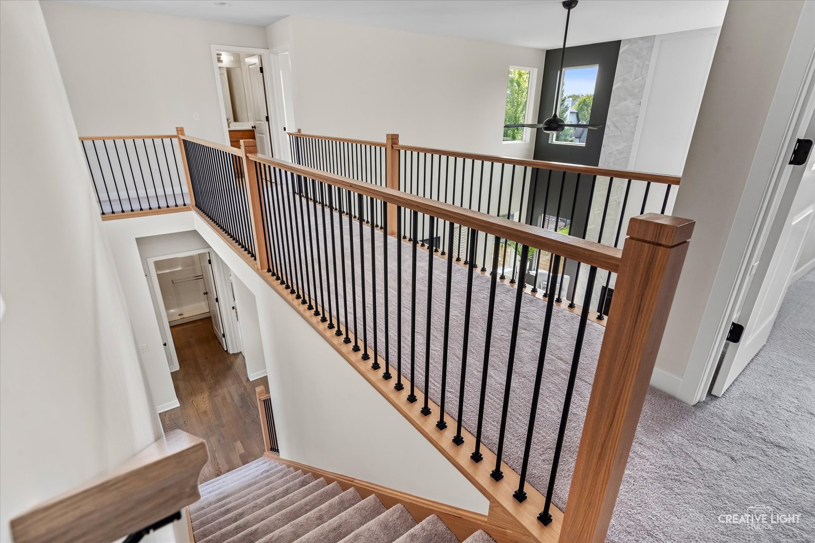 3959 Caliente Circle Naperville, IL 60564 - Photo 23 of 28 a view of staircase with lots of frames on wall and wooden floor