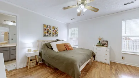 a bedroom with a large bed and a chandelier