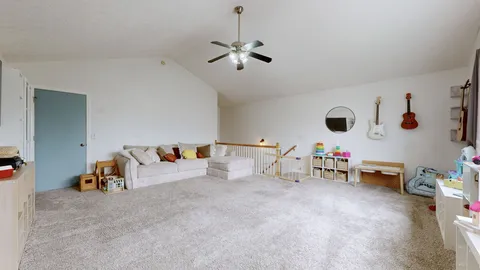 a living room with furniture and white walls