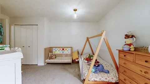 a hallway with a baby crib closet and a couch