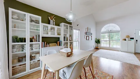 a view of a dining room with furniture window and wooden floor