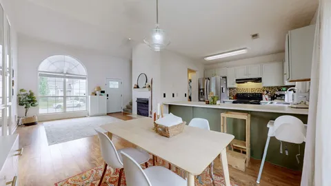 a kitchen with a table chairs sink and cabinets