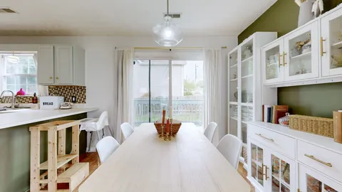 a very nice looking room with a large window and a dining table