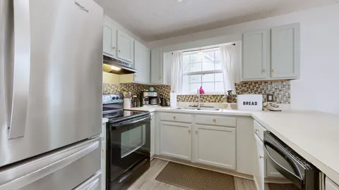 a kitchen with stainless steel appliances granite countertop a sink and cabinets