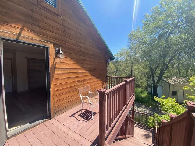 a view of balcony with wooden floor and fence