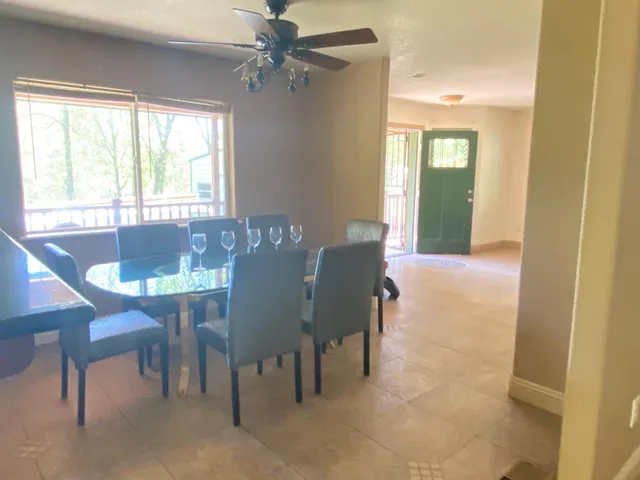 a view of a dining room with furniture and a window