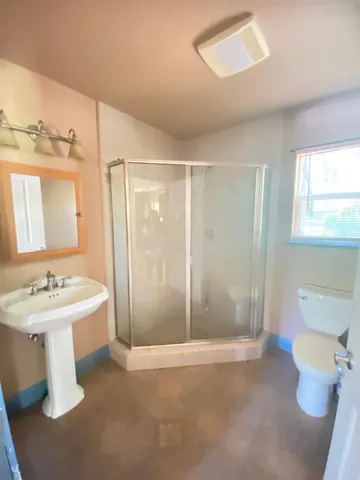 a bathroom with a sink toilet and shower