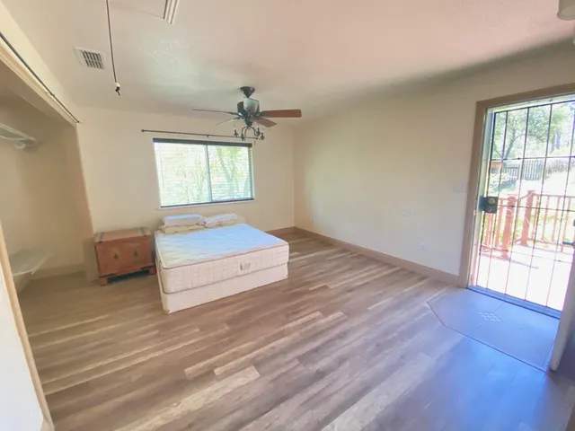 a spacious bedroom with a bed and a window