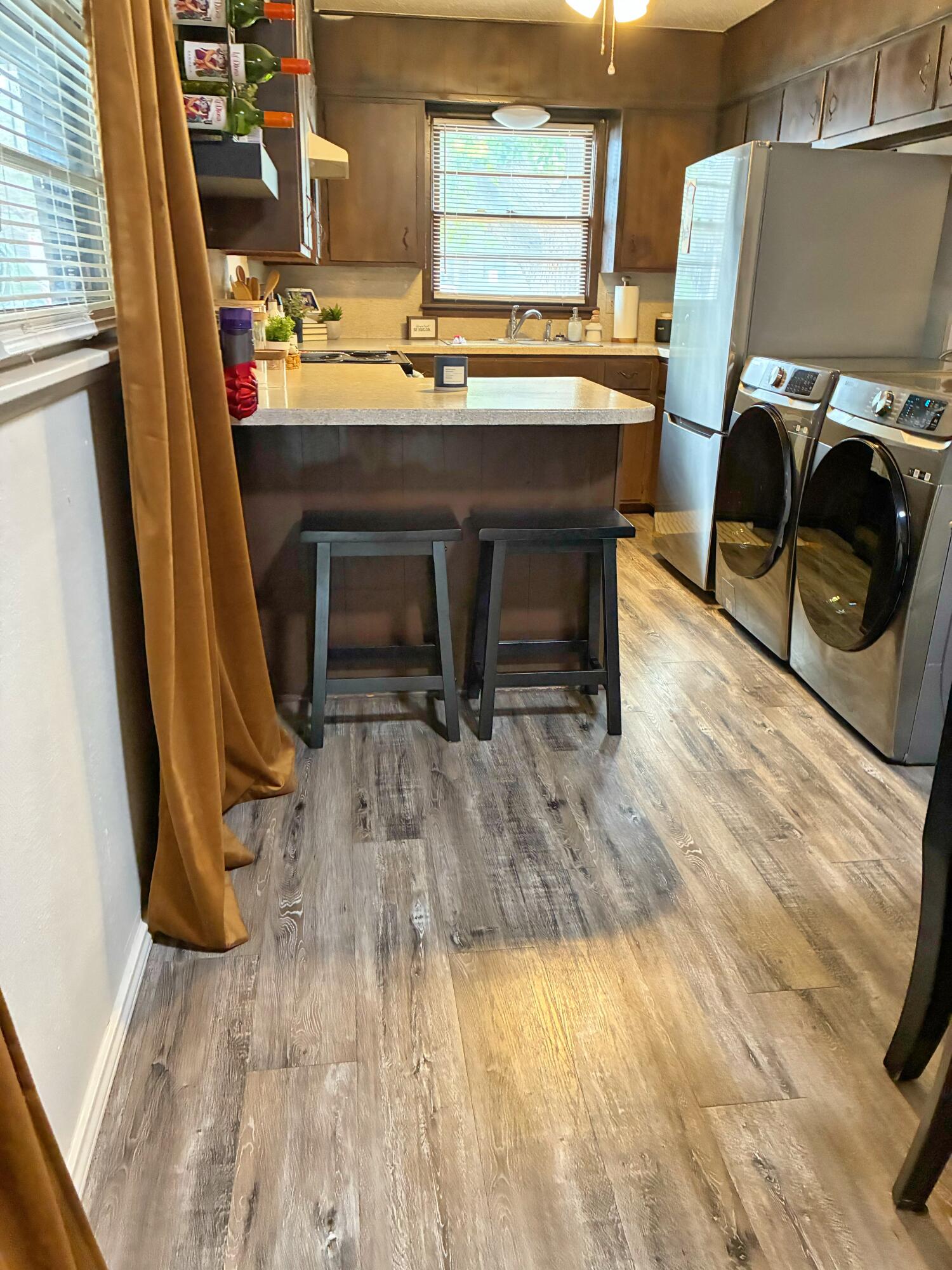4203 17th Street Lubbock, TX 79416 - Photo 6 of 15 a room with wooden floor and furniture
